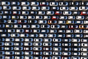 Aerial view of gleaming white and colored cars parked in neat rows create a captivating contrast of light and shadow, 1 Cliff Street, Fremantle, Western Australia, Australia.