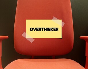 Office chair with stick note Overthinker - means one who dwells on thoughts, ideas and problems to an excessive degree - overthink and scrutinize every detail