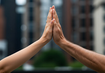 United arms forming triangle celebrating success on blurred background