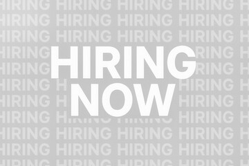 A bold text image featuring the words "HIRING NOW" in white on a gray background with repeated "HIRING" text, conveying an urgent job recruitment message.