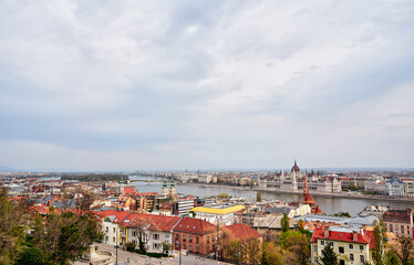 Fototapeta premium Scenic Cityscape Overlooking Historic Architecture and River on a Cloudy Day