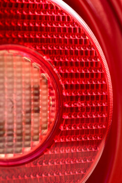 Detail of rear light or  tail-light of famous red Italian supercar. Rosso corsa is the red international motor racing color of cars entered by teams from Italy. Italian national racing color