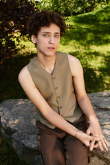 Stylish young man enjoying a sunny day in a vibrant green park