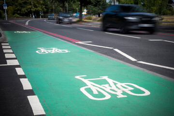Green cycle lane alongside busy main road