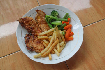 Wholesome Grilled Chicken Steak with Fries and Fresh Vegetables