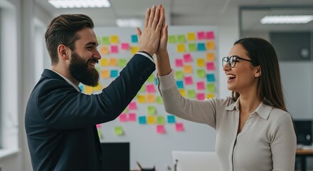 Happy business partners exchanging a high five in front of a wall covered with brainstorming notes, symbolizing teamwork and achievement, stock photography style.