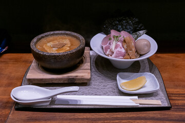 A set dinner package of pork ramen noodles and pork slices served in a restaurant