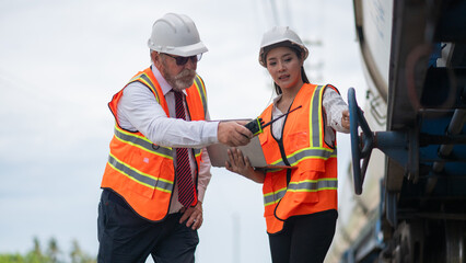 Engineer manager and a secretary working together railway track during inspection or routine...
