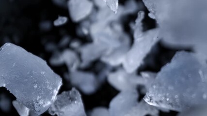 Super Slow Motion Shot of Ice Pieces Flying Towards Camera on Black Background at 1000fps. - Powered by Adobe