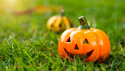 Ceramic pumpkin for Halloween on green grass lawn. Autumn holiday. Fall season.