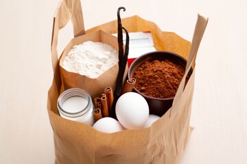 Paper grocery bag filled with baking ingredients for a recipe