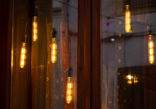 warm light hanging lamps decorative illumination garland windows fuzzy reflection dusk background space