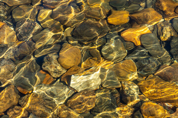 Berg, Sweden Pebbles and rocks on the shore of a pristine lake.
