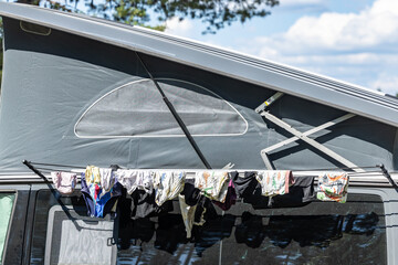 Nasteln, Sweden Personal laundry drying on a clothes line outside a camping van at a beach.