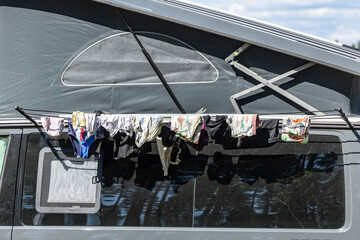 Nasteln, Sweden Personal laundry drying on a clothes line outside a camping van at a beach.