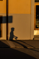 Stockholm, Sweden  A shadow of an electric scooter on a house facade on Vattenledningsvägen in the Midsommarkransen district at sunset.