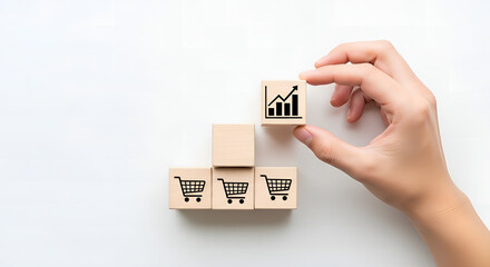 Retail Growth Strategy Hand Placing Graph Block on Shopping Cart Blocks, Illustrating E-commerce Success and Business Development
