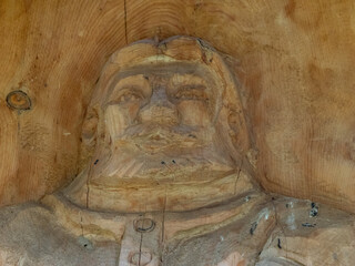 Wooden carving of bearded man figure

