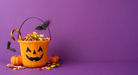 Festive Halloween pumpkin bucket with assorted candy and colorful decorations on a side view desk vibrant backdrop