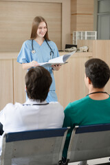Team Doctor listening medical Caucasian woman student present at hospital