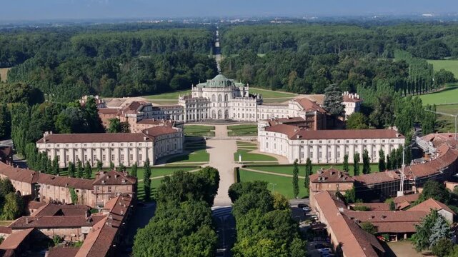Aerial view of the Palazzina di Caccia, a grand hunting lodge, surrounded by lush green forests and meticulously manicured gardens, Stupinigi, Piemonte, Italy.