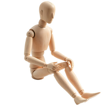 Wooden mannequin sitting on a white background. Isolated