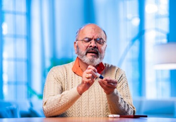 Concerned Indian senior checks sugar level and calls to share bad news about health