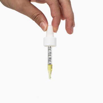 hand holding a liquid droper