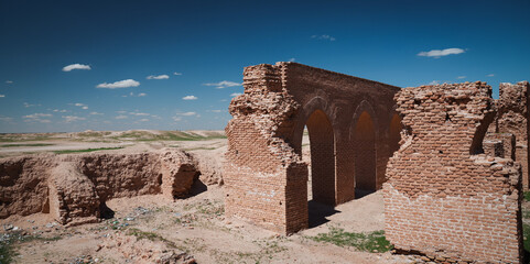 Ruins of Abu Dulaf in Iraq showcasing ancient architecture against a clear blue sky