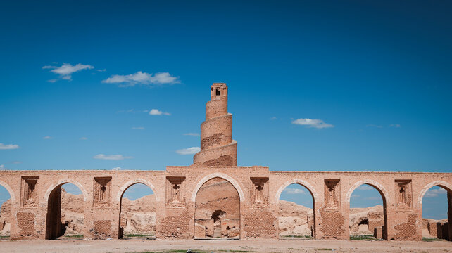 Historic architecture of Abu Dulaf showcases ancient ruins against a clear blue sky - Powered by Adobe
