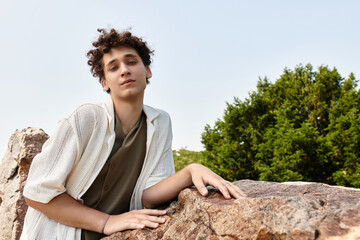Stylish young man enjoying a sunny day in a vibrant green park