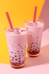 Tasty milk bubble tea in glasses on color background