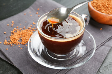 Making instant coffee at black table, closeup