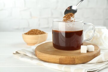 Making instant coffee at light table, closeup