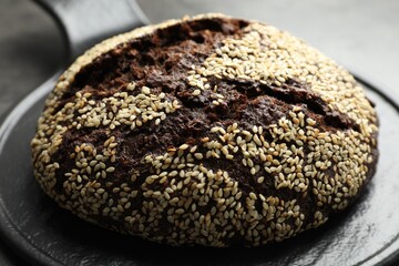 Fresh rye bread with seeds on table, closeup