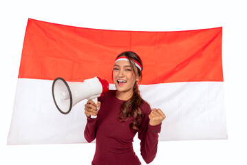 Indonesian southeast asian woman celebrating Indonesia Independence Day on 17th of August holding...