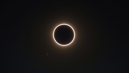 A solar eclipse with the moon creating a ring of light around its dark silhouette. Astronomical event, cosmic phenomena, celestial alignment. The phenomenon of a radiant solar ring.