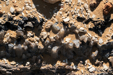 Close-up of a natural quartz formation inside a cave. The detailed crystal structure and layers of the mineral
