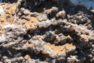 Close-up of a natural quartz formation inside a cave. The detailed crystal structure and layers of the mineral