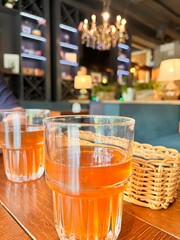 glasses with dried fruit compote on a table in a restaurant on a blurred background