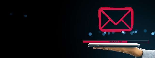 Email sending progress bar with red envelope icon hovering above digital tablet held by hand on...