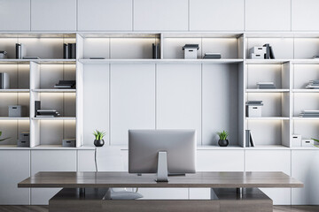 Modern executive office interior with sleek desk, computer, and stylish shelving in a bright...