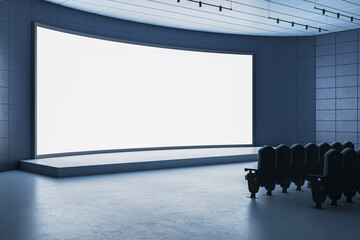 Modern auditorium with blank curved digital display and empty seats in futuristic conference or...