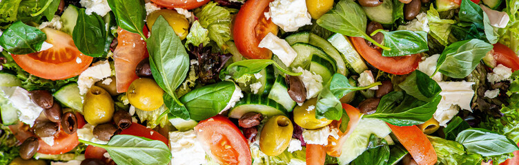 Healthy vegetable salad of fresh tomato, green leaves mix and vegetables. Top view banner horizontal. Diet menu background