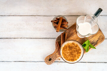 Cinnamon honey milk drink. Dreamy Nighttime Drink, night time warm, relaxing and delicious cinnamon dairy or non-dairy beverage with honey and cinnamon powder, copy space