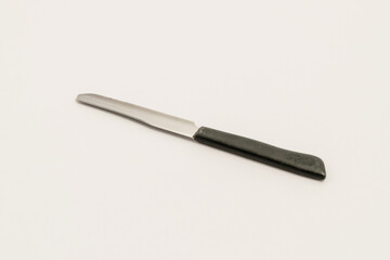 A kitchen knife with rounded end-shaped for safety, isolated on a grey surface