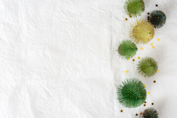 Christmas themed decorations on paper texture background. green Christmas tree and gold glitter star, Top view image.