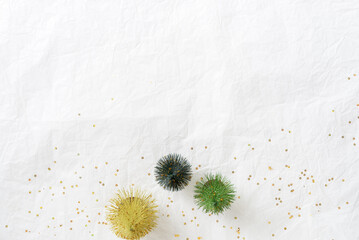 Christmas themed decorations on paper texture background. green Christmas tree and gold glitter star, Top view image.