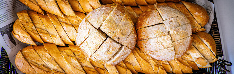 Fresh fragrant breads on the table. Bakery food concept panorama or wide banner photo background
