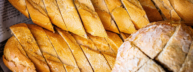 Fresh fragrant breads on the table. Bakery food concept panorama or wide banner photo background